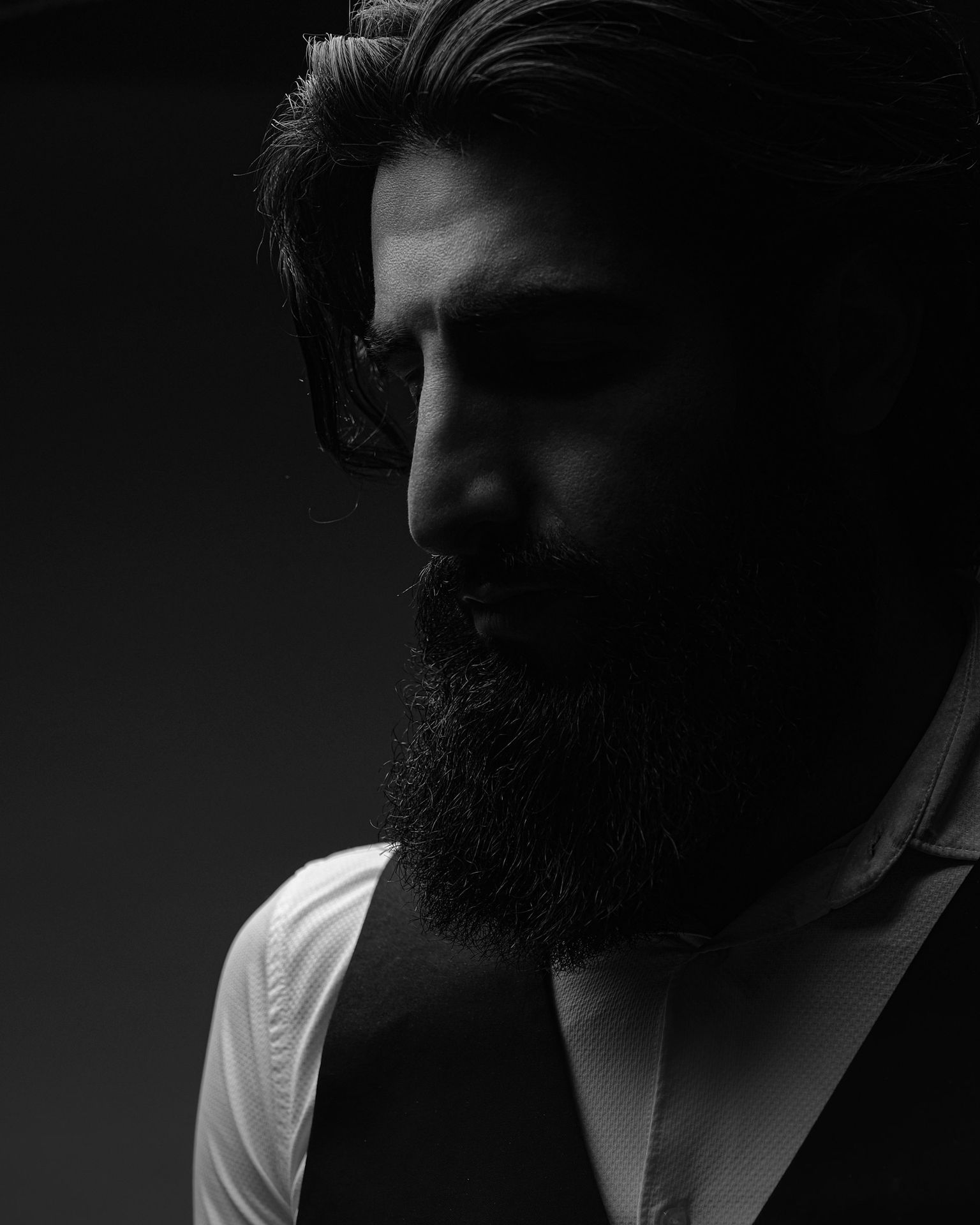a black and white photo of a man with a beard